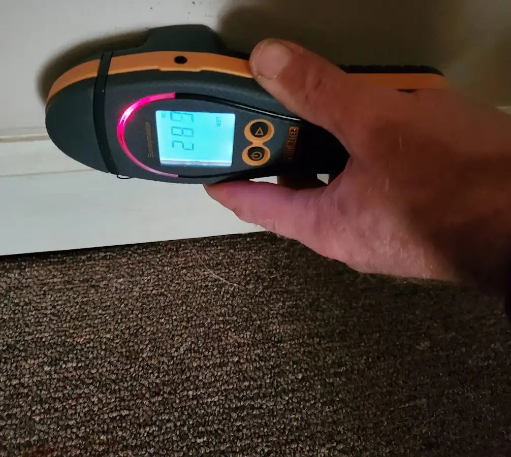 Moisture detection at baseboard during Storm Damage Restoration in Fairborn